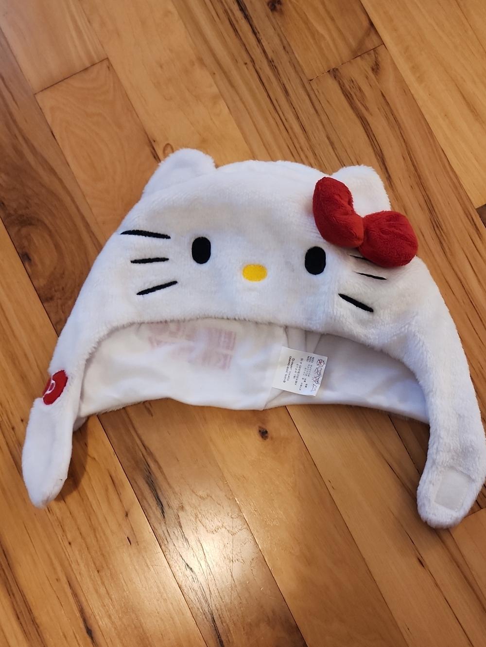 Hello Kitty White Plush Earflap Hat with Red Bow and Yellow Nose - Kids